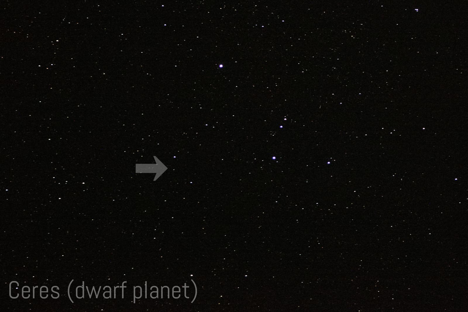 Dense starfield with a white arrow and text label pointing out the dwarf planet Ceres, which looks like an ordinary faint star.