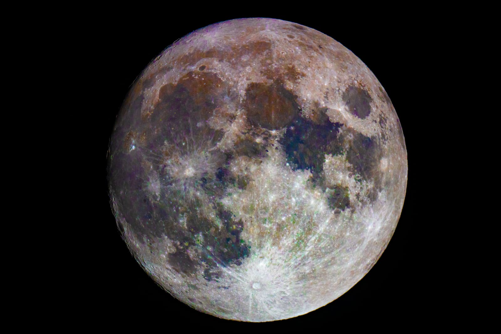 A full moon rendered in exaggerated false color, with patches of purple, brown, blue and grey across its surface.