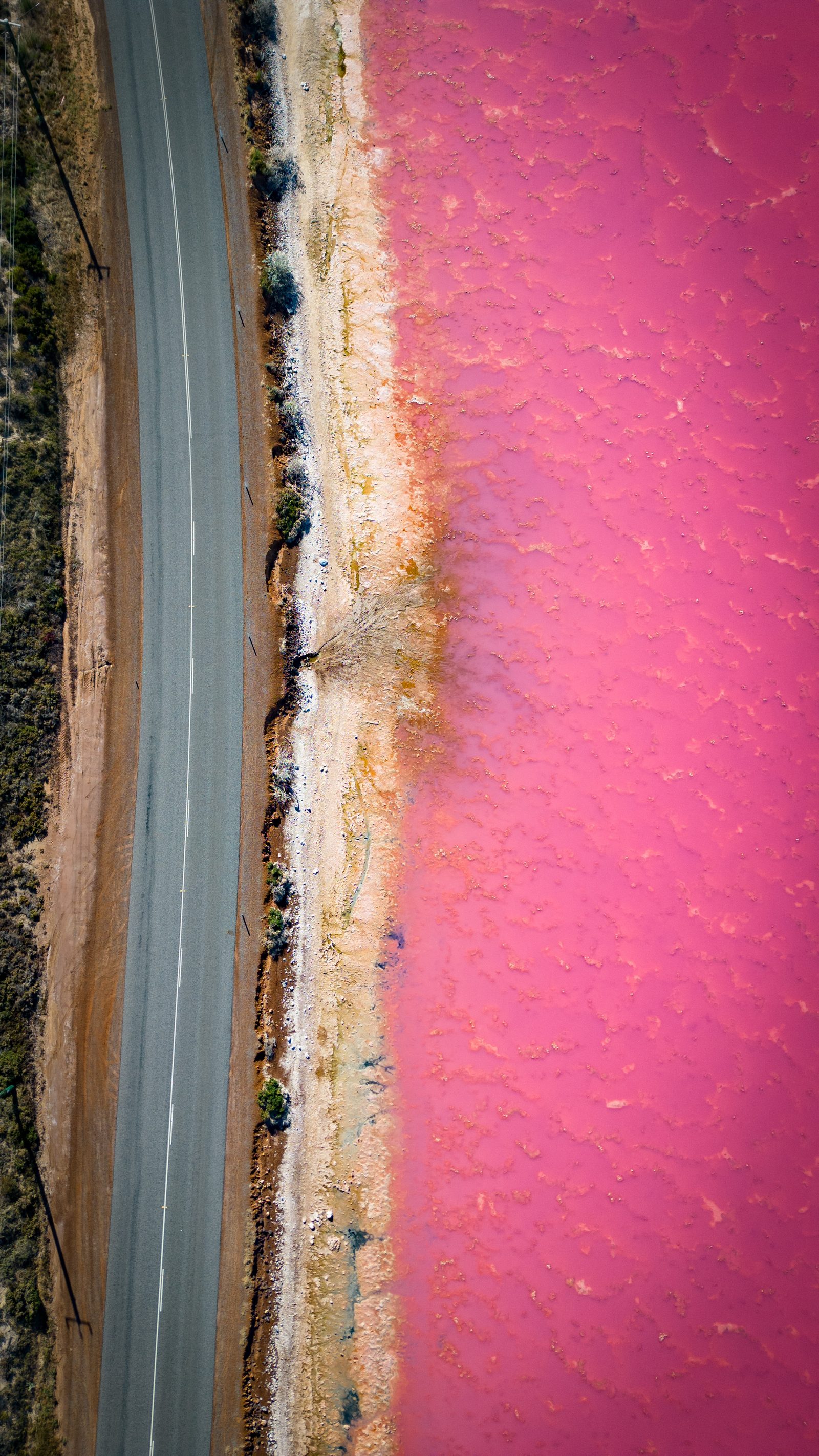 A pink salt lake photographed during the 2023 Australia eclipse expedition.