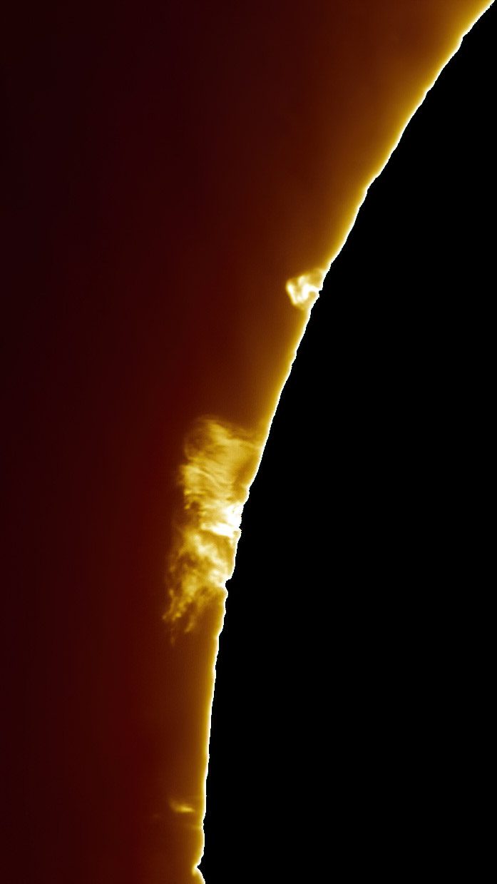 A close-up of a prominence arcing off the Sun's limb.